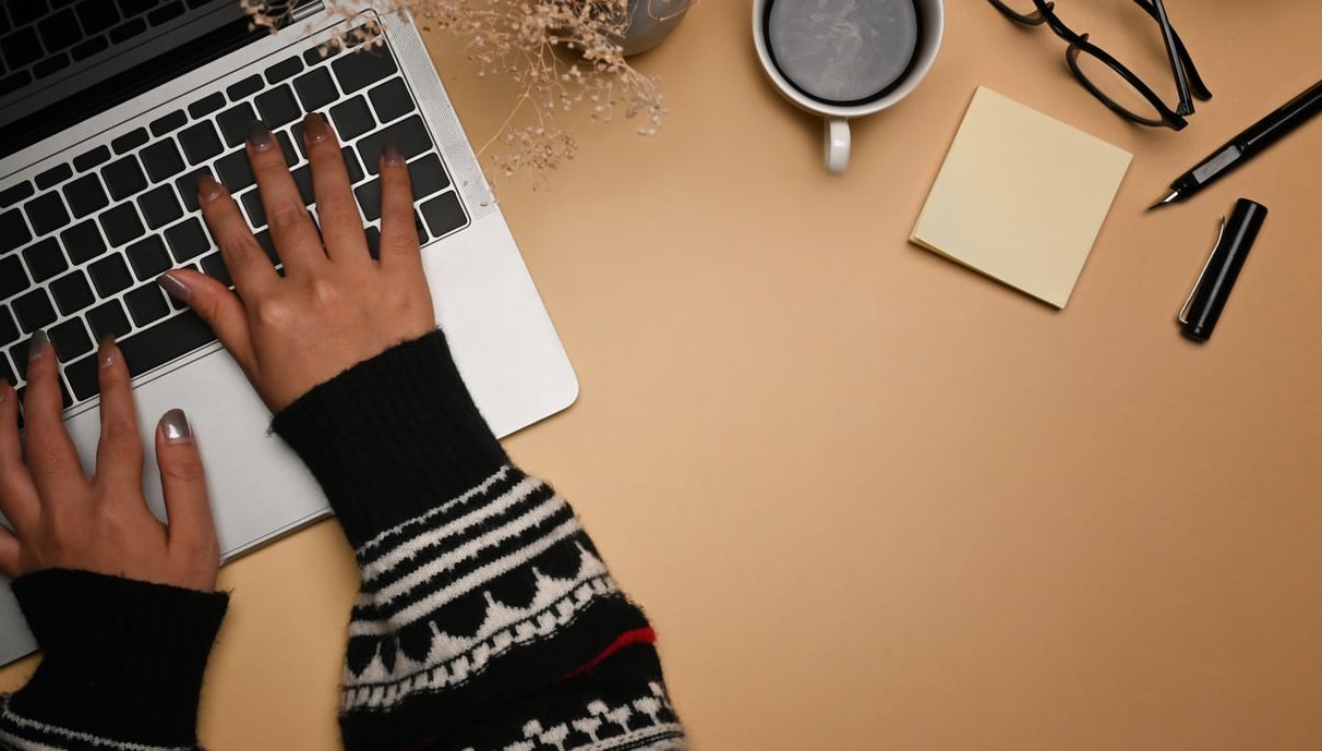 person typing ad on computer